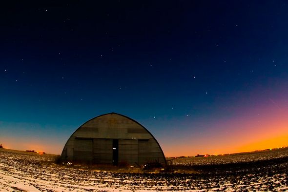 a hangar in a field