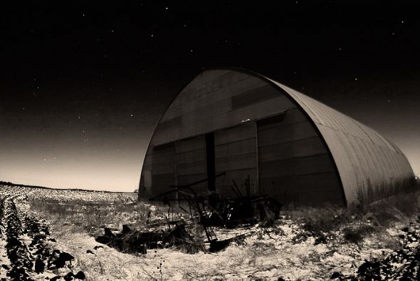 a hangar in a field 2