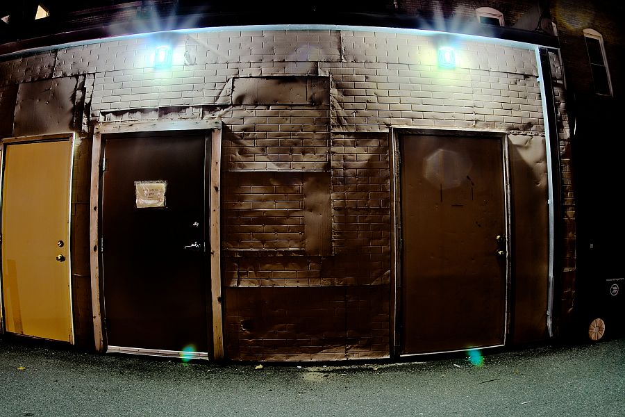 one wall, two fluorescent lights, three doors